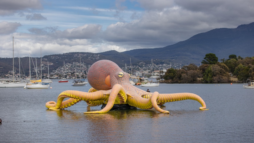Inflatable octopus artwork in marina.