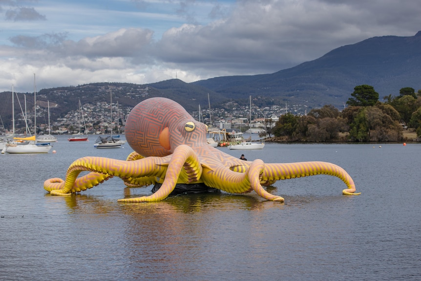 Inflatable octopus artwork in marina.