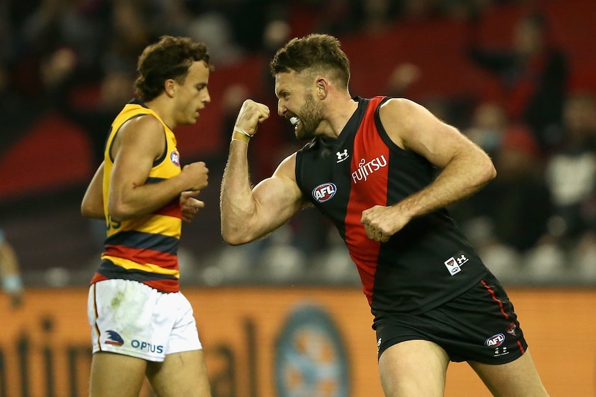 An Essendon AFL player pumps his right fist as he celebrates a goal against the Adelaide Crows.