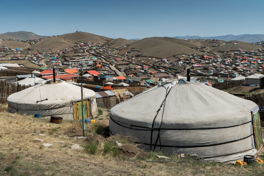 Hills covered in small houses in a town in Mongolia.