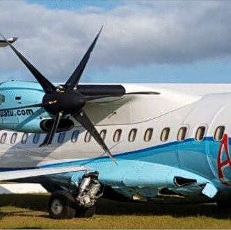 The right fuselage of an Air Vanuatu plane is badly damaged after it collided with two other parked planes at Port Vila airport.