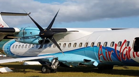 The right fuselage of an Air Vanuatu plane is badly damaged after it collided with two other parked planes at Port Vila airport.