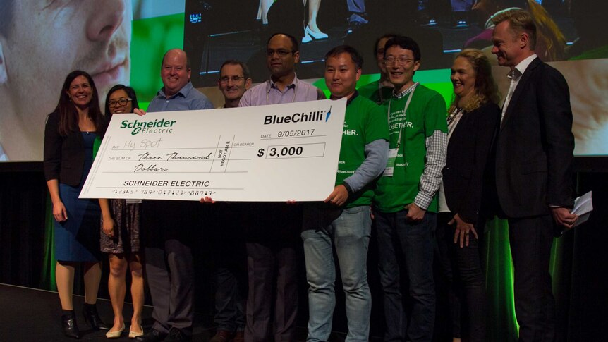 Winning hackathon team accept their prize-money