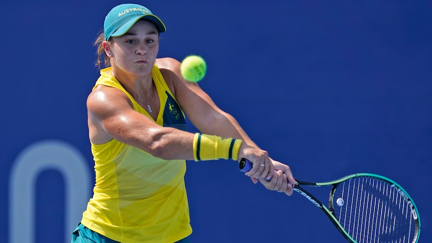 An Australian female tennis player prepares to play a backhand at the Tokyo Olympics.