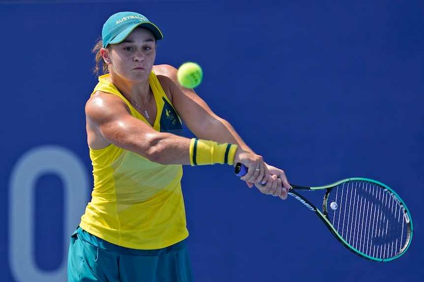 An Australian female tennis player prepares to play a backhand at the Tokyo Olympics.