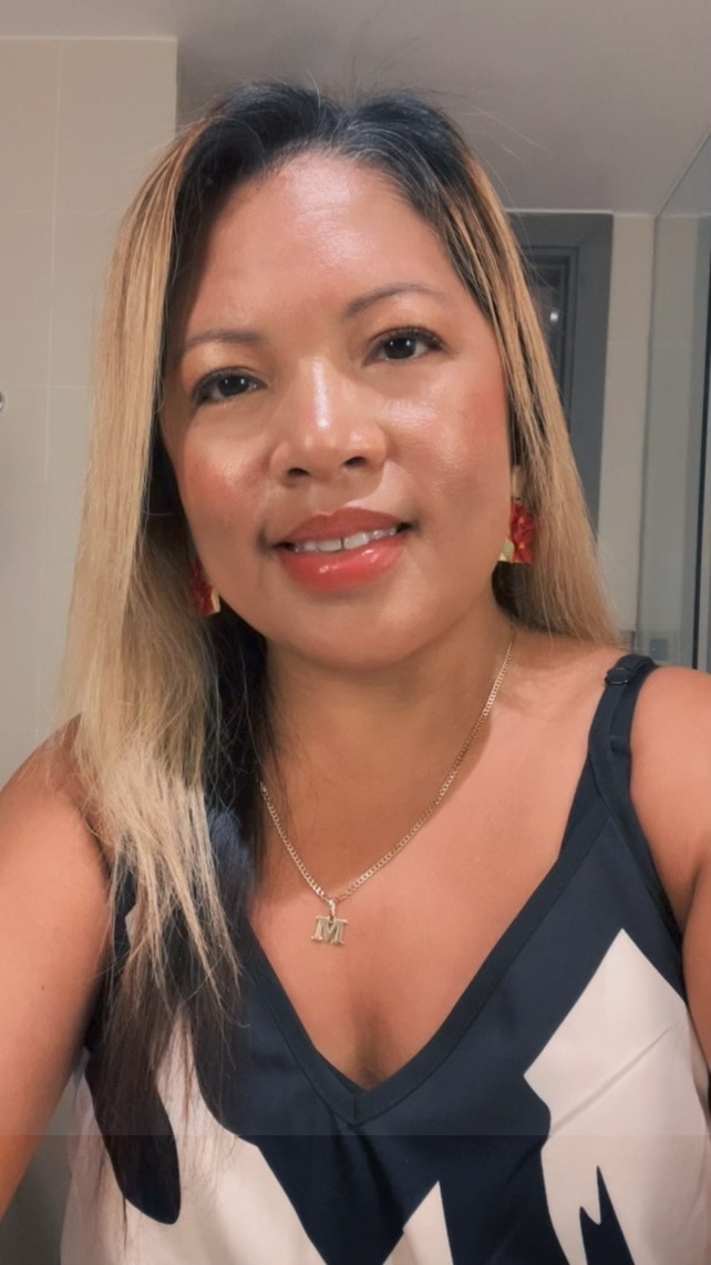 A Filipino woman with blonde highlights in her hair wearing pink lipstick and blush