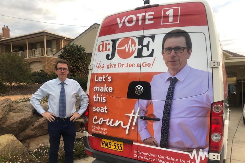 Dr Joe in front of a van