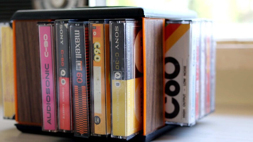 Several cassette tapes rest in a spinning holder.