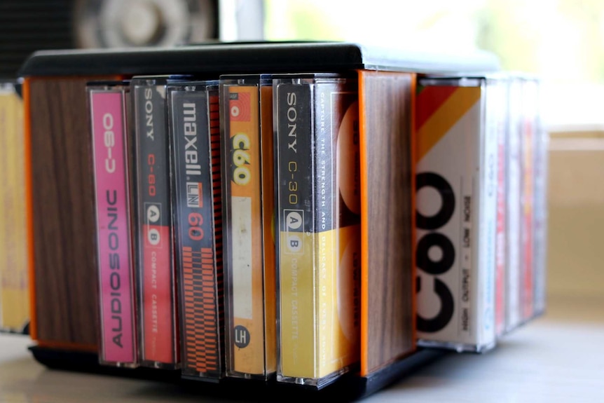 Several cassette tapes rest in a spinning holder.