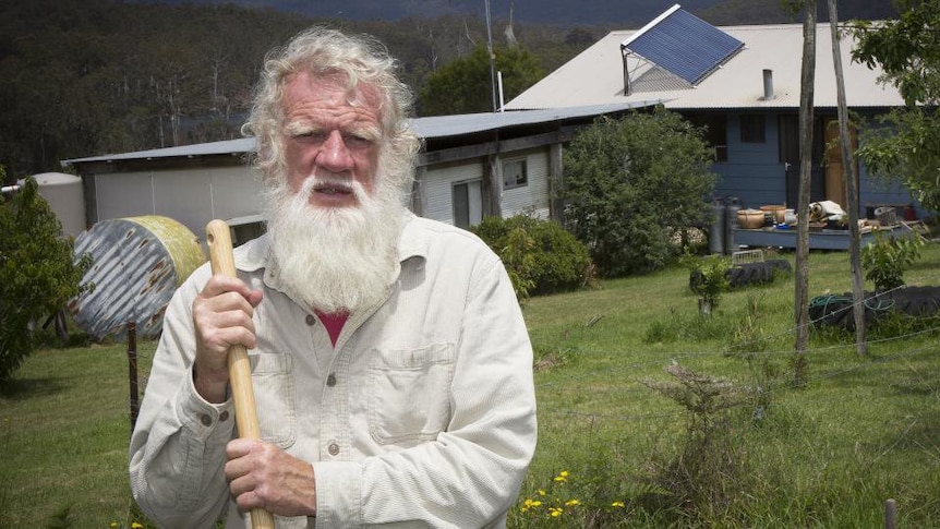 Bruce Pascoe, the author of Dark Emu, pictured with a farm house in the background.