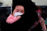 A child wears a mask to prevent an outbreak of a new coronavirus in Hong Kong.