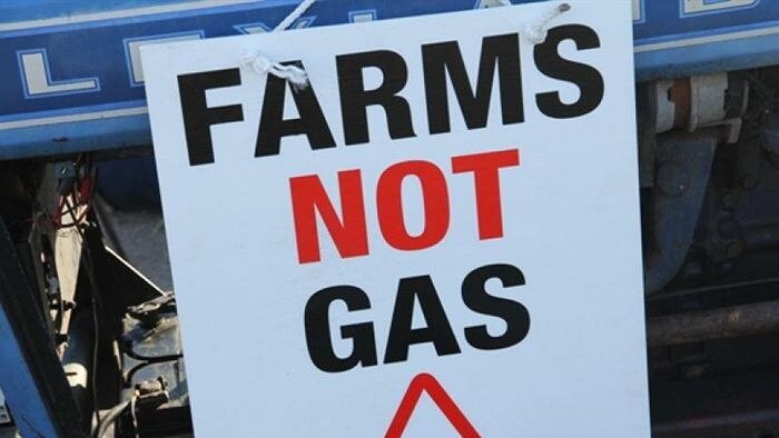 A sign, protesting against unconventional gas mining, reads 'farms not gas, lock the gate'