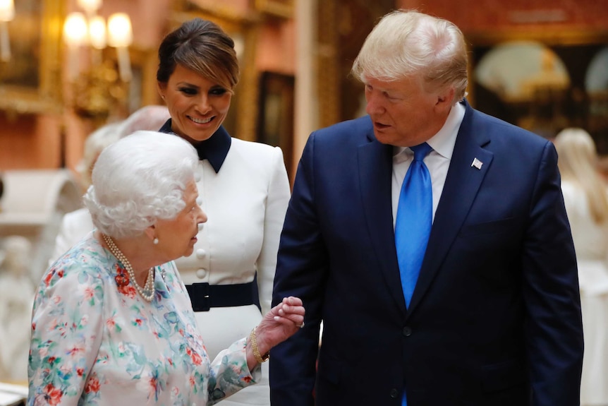 Britain's Queen Elizabeth speaks to US President Donald Trump and First Lady Melania Trump