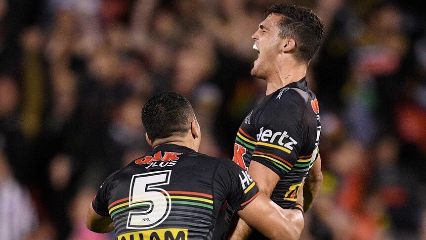 Nathan Cleary screams out in celebration as he jumps in the air, while Dallin Watene-Zelezniak runs to hug him.