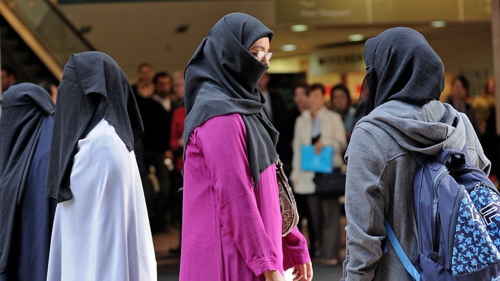 Women gather in protest against Europe's face veil bans.