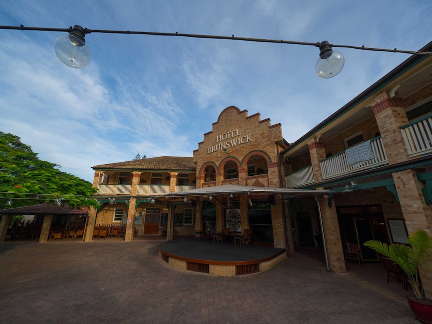 Festival lights hang above an empty beer garden at Hotel Brunswick