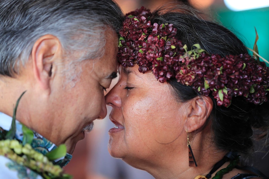 A close-up shows a man and woman with noses touching. A tear slides down the cheek of the woman.