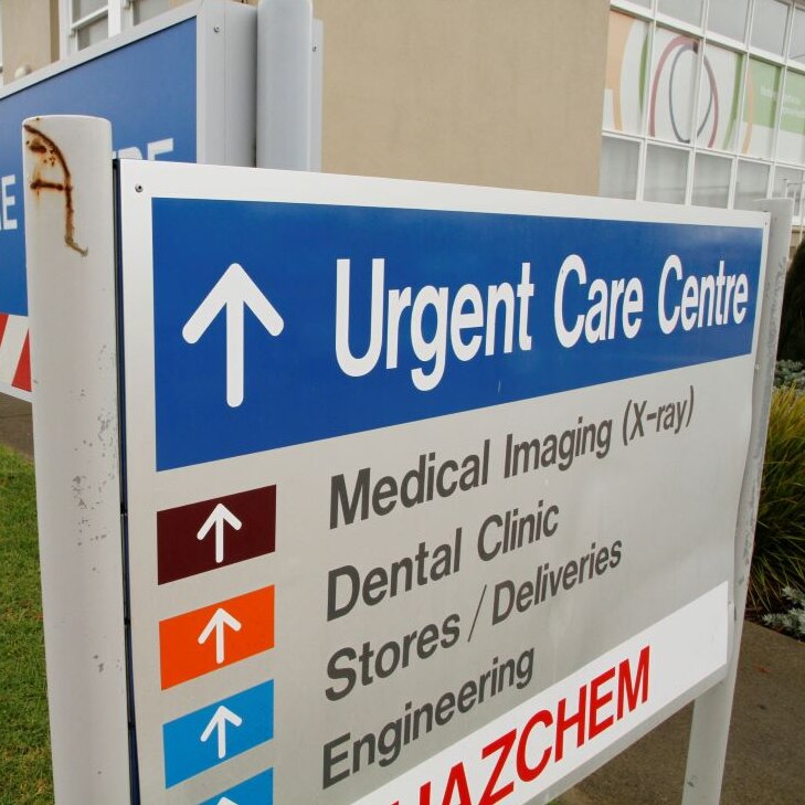 A sign pointing to the urgent care centre, medical imaging and dental clinic outside a single-store hospital building.