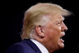 Donald Trump shot in profile, with his mouth open as he speaks 
