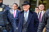 Roger stone smiling outside of court after his sentencing.