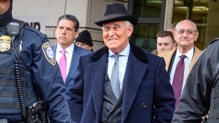 Roger stone smiling outside of court after his sentencing.