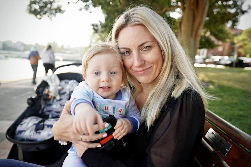 A woman holding a baby.