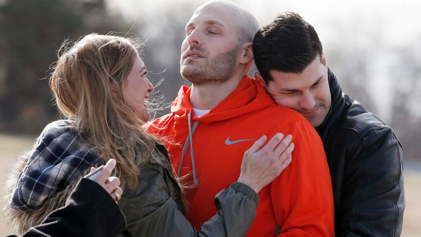 Michael Behenna is embraced by his brother Brett and girlfriend Shannon Wahl following his release from prison in 2014.