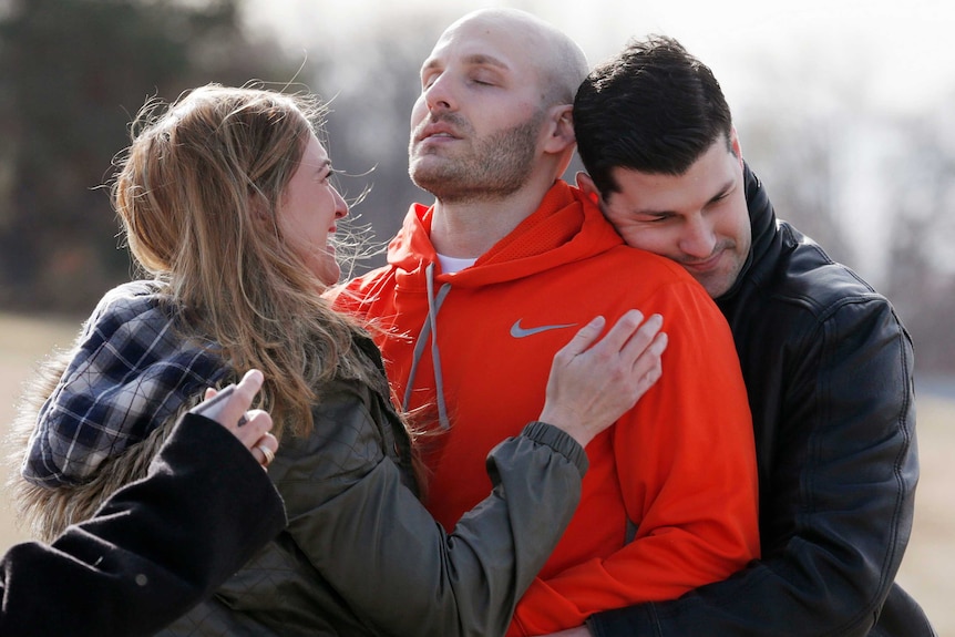 Michael Behenna is embraced by his brother Brett and girlfriend Shannon Wahl following his release from prison in 2014.
