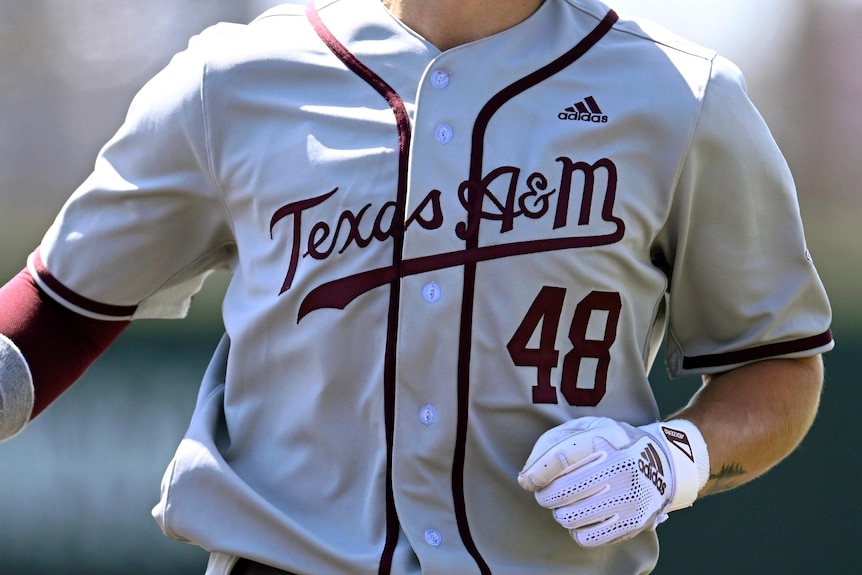 A Texas A&M college baseball player  runs during a game. He is number 48.