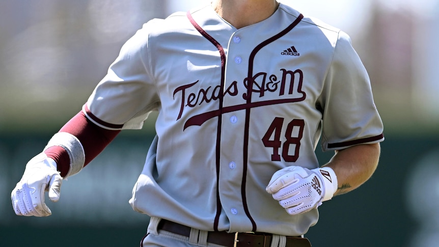 A Texas A&M college baseball player runs during a game. He is number 48.