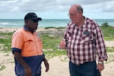 Warren Entsch talking to a Torres Strait Islander with the sea in the background.