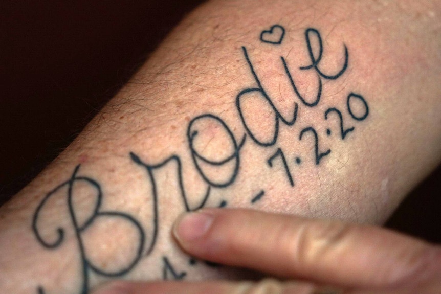 A man's arm with the name Brodie printed on it.