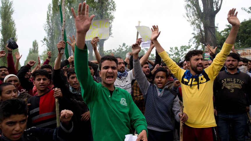 Kashmiri men shout slogans during a protest against the alleged rape of a three year old girl.