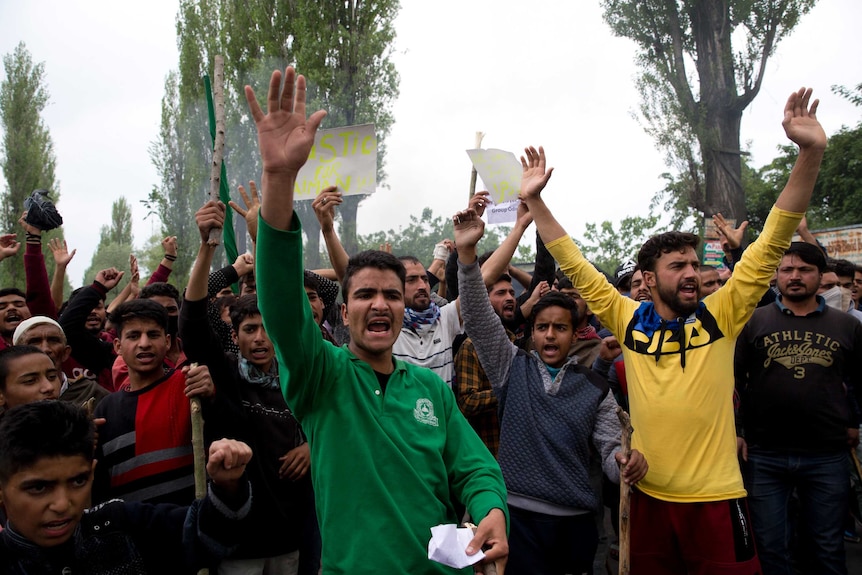 Kashmiri men shout slogans during a protest against the alleged rape of a three year old girl.
