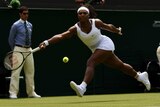Serena Williams hits a running forehand in her Wimbledon opener