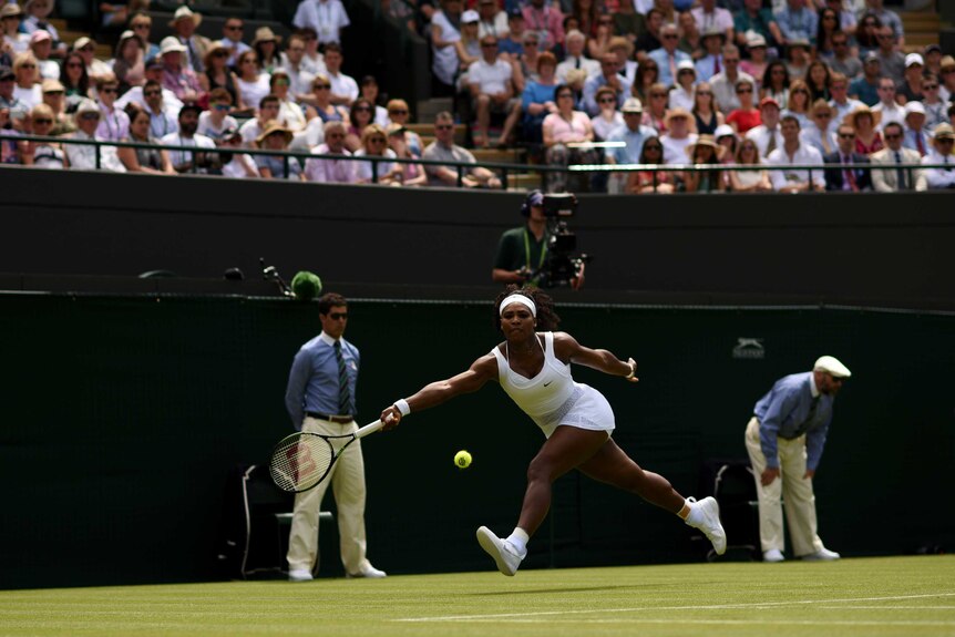 Serena Williams hits a running forehand in her Wimbledon opener