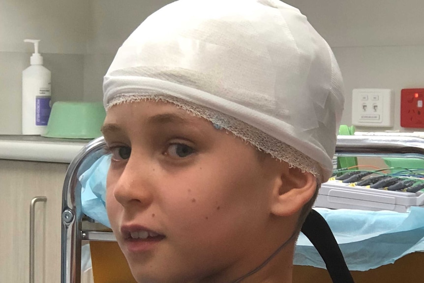 Lewis Railton with bandages around his head at hospital.