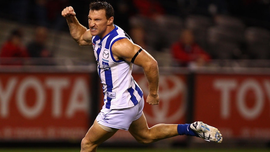 Best on ground... Kangaroos captain Brent Harvey celebrates a goal within the first minute at Docklands.