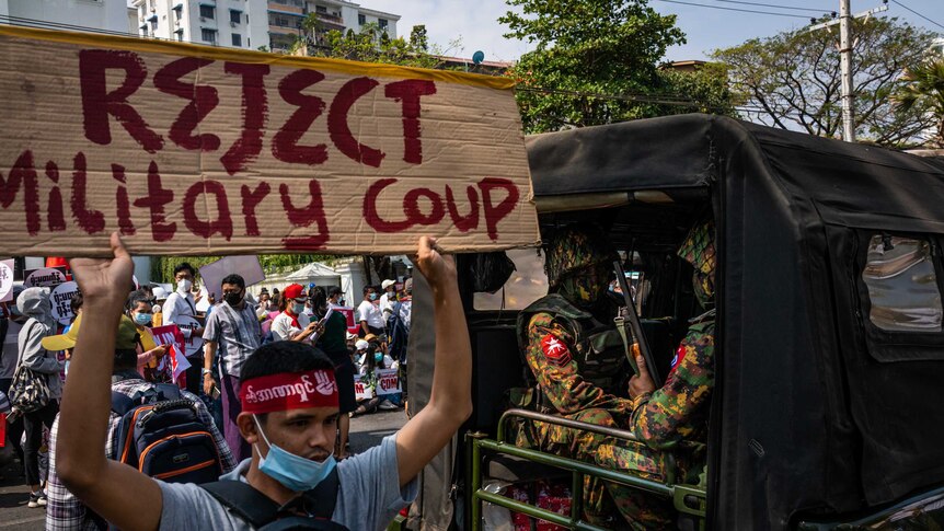 Protesters holding up a sign resisting the military coup in Myanmar.