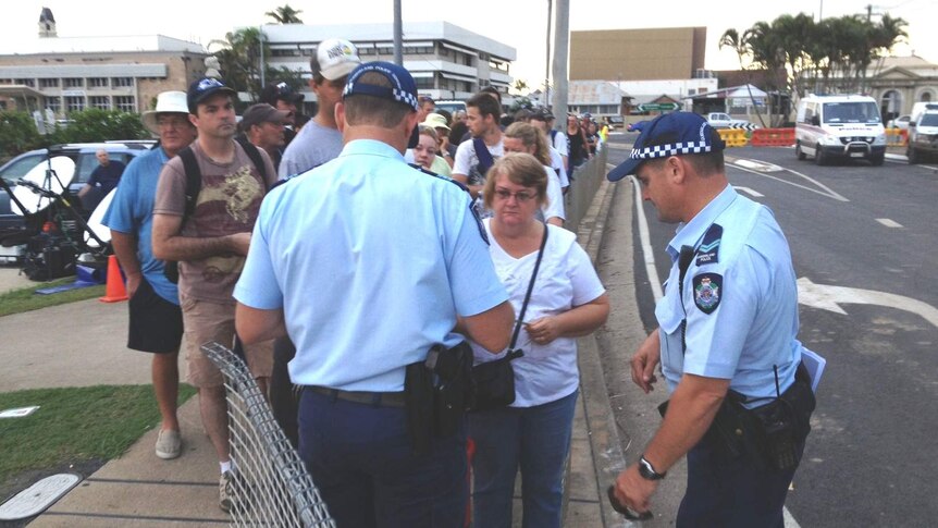 Police check identification of residents returning to homes within the North Bundaberg exclusion zone.