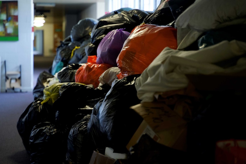 Bags of rubbish charity donations piled up.