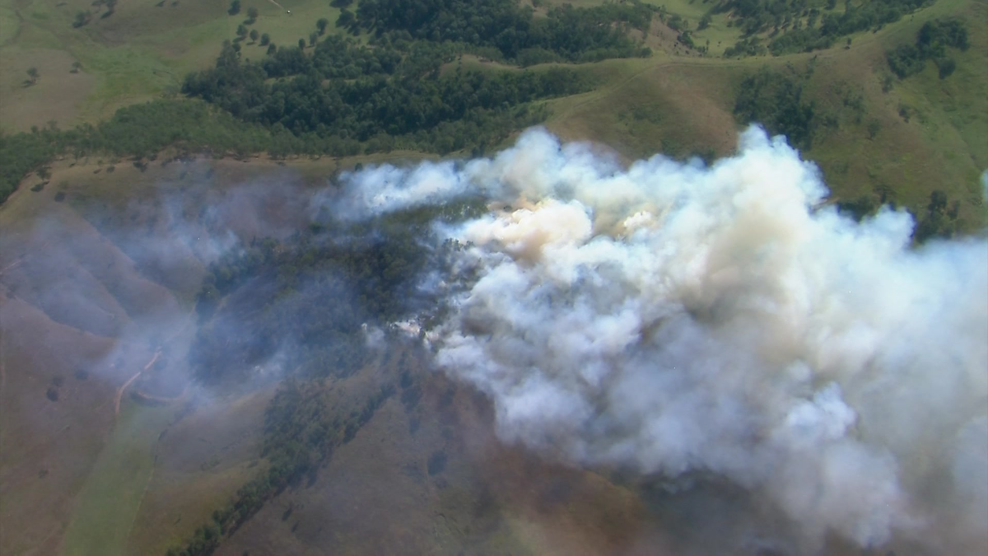 Dozens of bushfires burn as Qld swelters through above-average temps