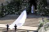 Meghan Markle arrives at St George's Chapel, her five-metre veil is across the steps.
