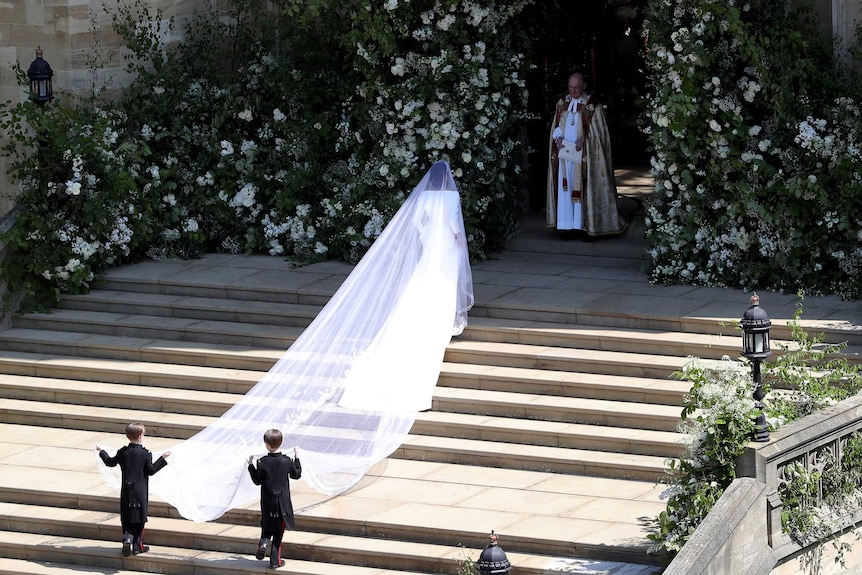 Meghan Markle arrives at St George's Chapel, her five-metre veil is across the steps.