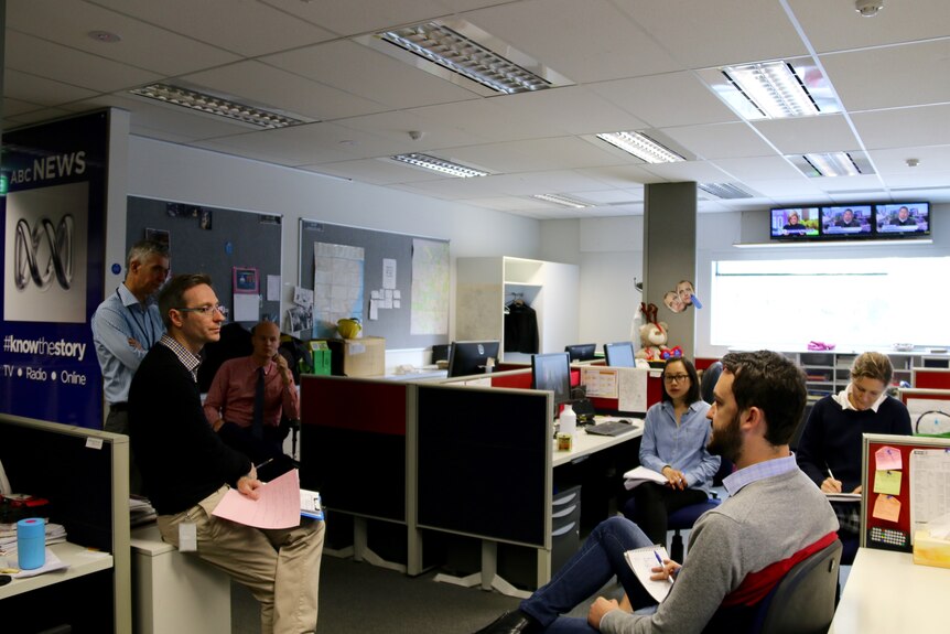 Staff gather for a daily editorial meeting at ABC News Canberra