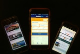 Three mobile phones showing various accommodation booking sites.