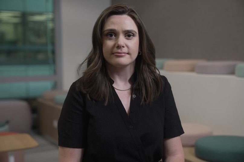 Eliza Owen stares at the camera in an office. 