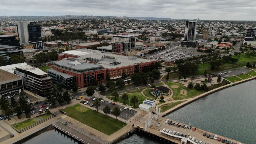 A drone photo of Geelong CBD, a regional city with a handful of high-rise buildings by the water.