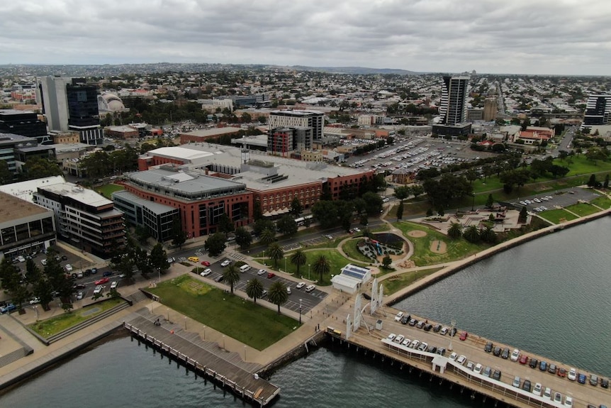 A drone photo of Geelong CBD, a regional city with a handful of high-rise buildings by the water.