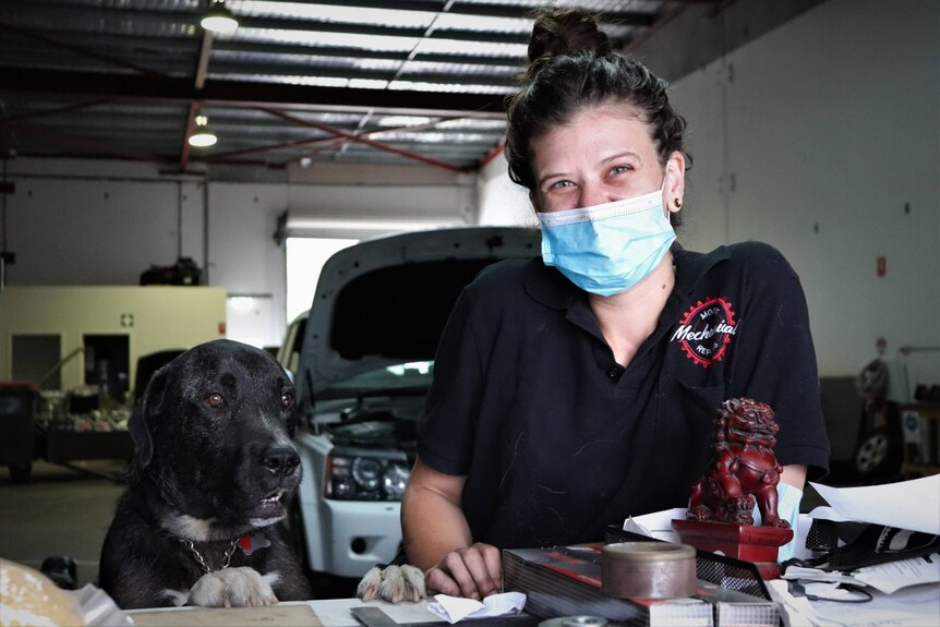 Mechanic, Madeline Moore with her dog, Wally.